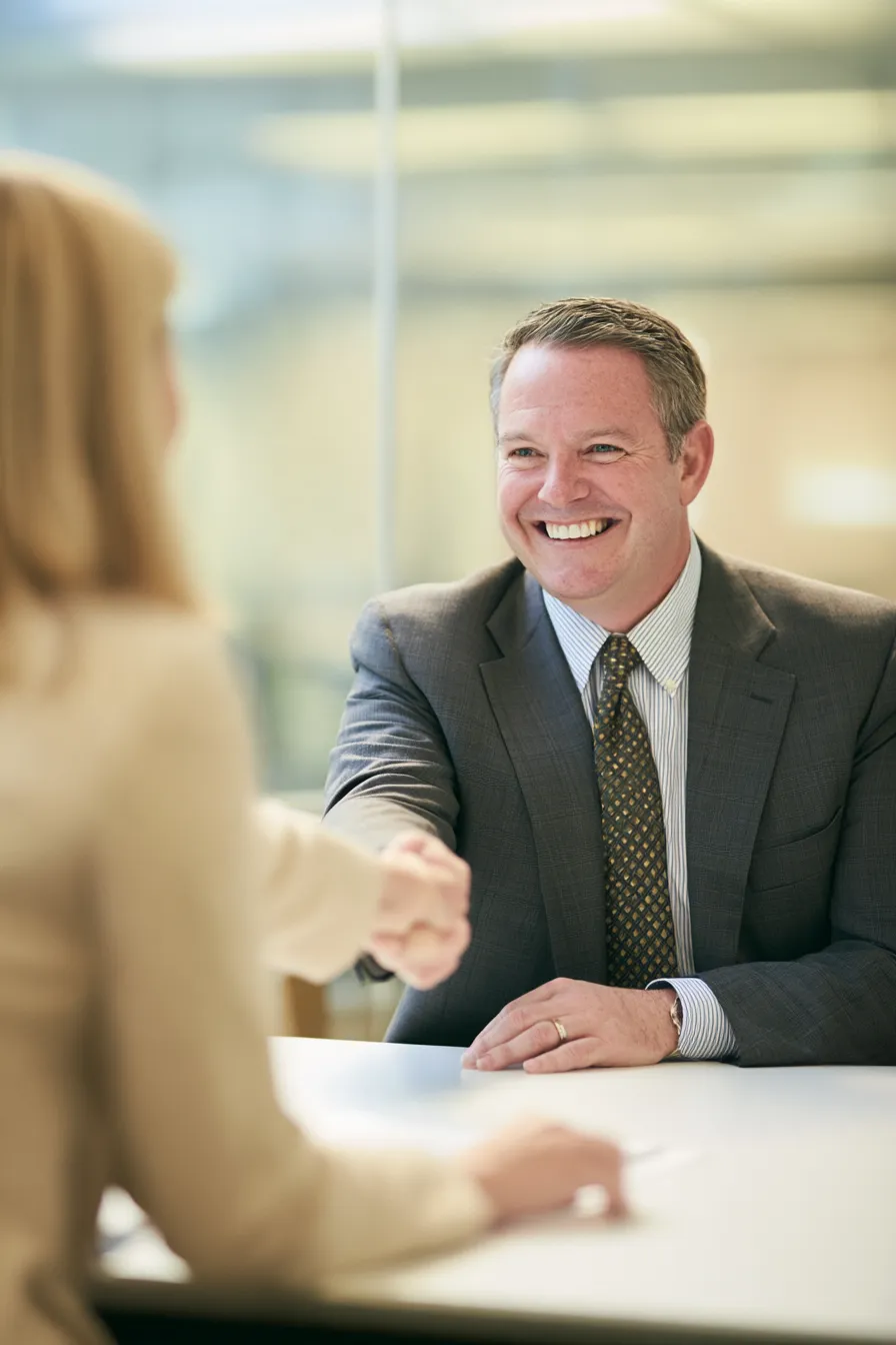 Borrower and Oliv Financial network advisor shaking hands over a personal personal loan agreement